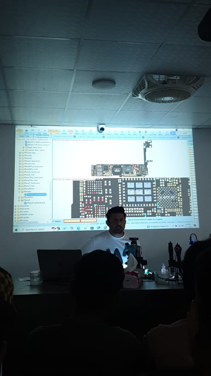 Momin Ali working with microscope at iPhone Fix Lab
